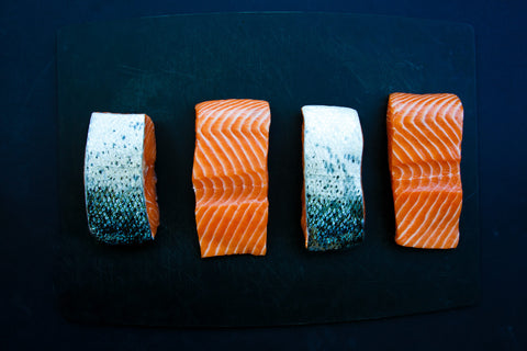 high quality fresh seafood on a navy blue cutting board