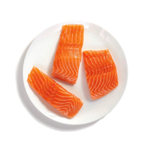 three 5 ounce fresh Norwegian salmon portions on a white plate