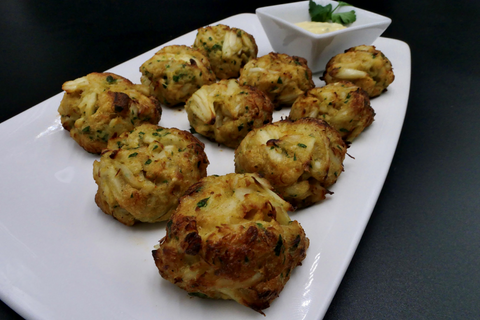 10 baked mini crab cake bites served on a white plate