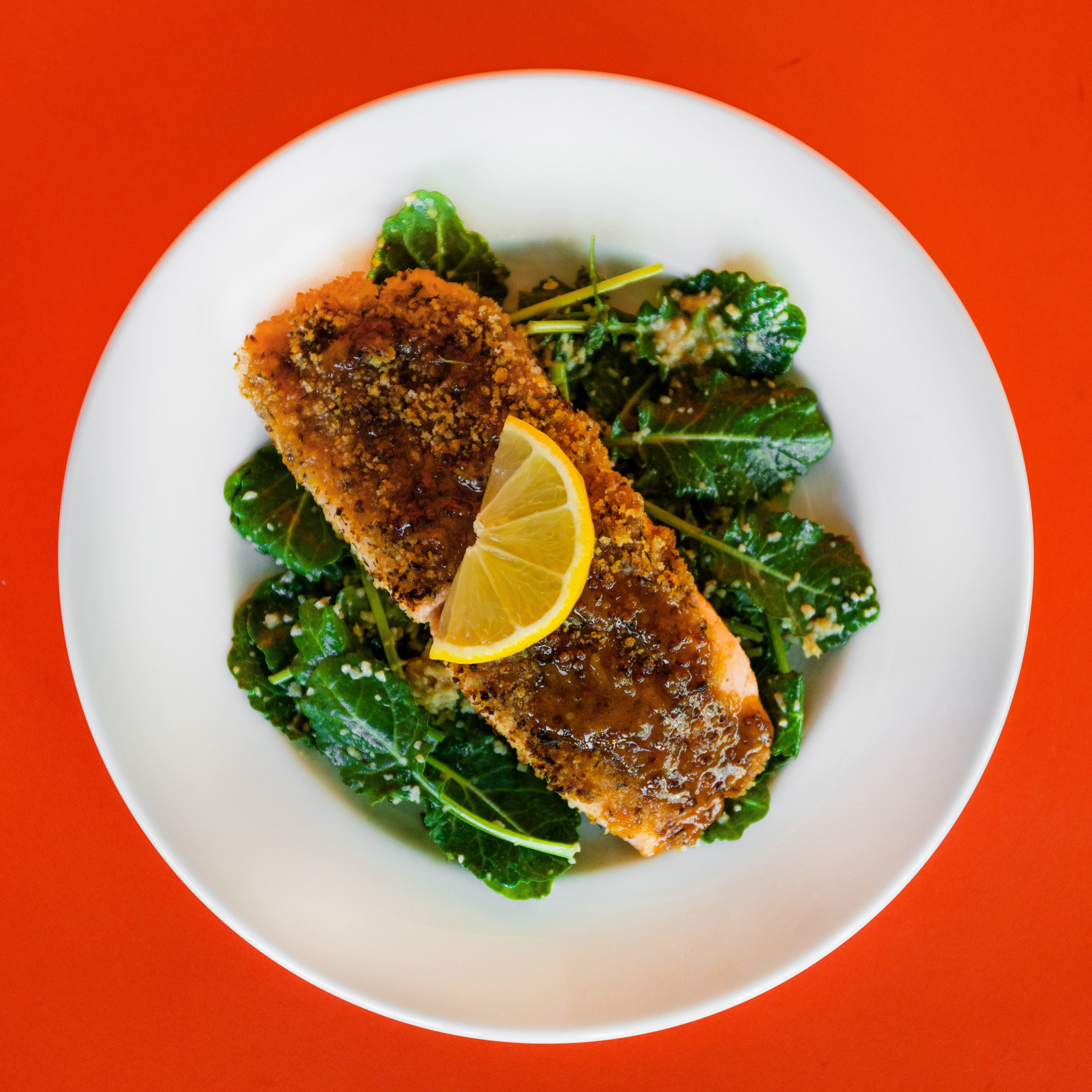 Honey Mustard Norwegian Salmon on a plate of greens