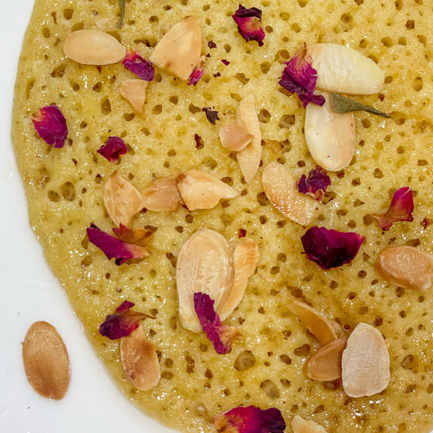 Moroccan Baghrir honeycomb pancake with almonds and rose petals