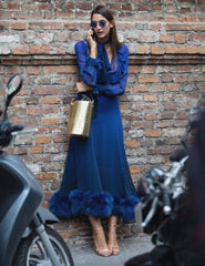 Woman looking pensive wearing a dress in classic blue