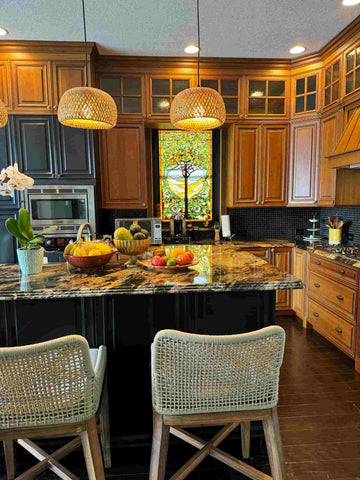 A kitchen featuring old-fashioned honey oak cabinets mixed with modern black cabinets and bamboo light fixtures