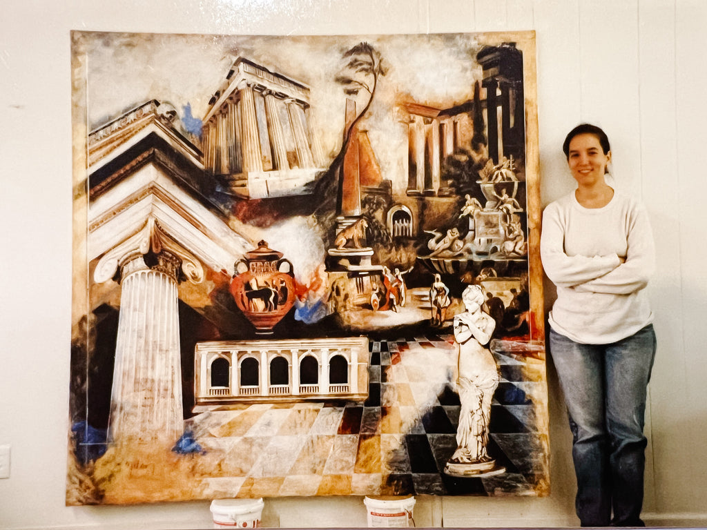 Artist Elli Milan standing next to her large canvas artwork of Greek structures and statues