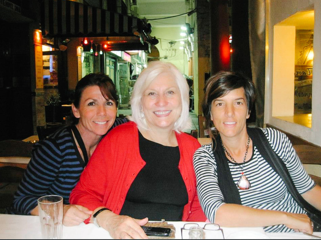 Three beautiful ladies smiling while enjoy dinner and travel