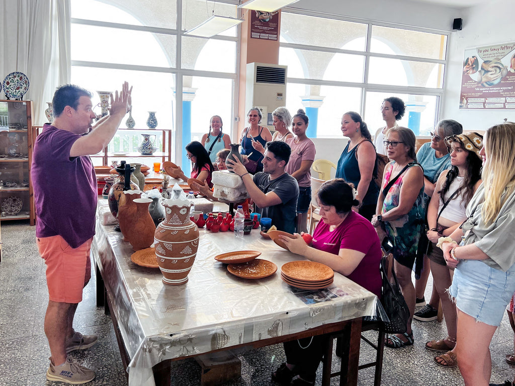 Greek Master Potter explains the pottery-making process to a group of traveling artists in Greece