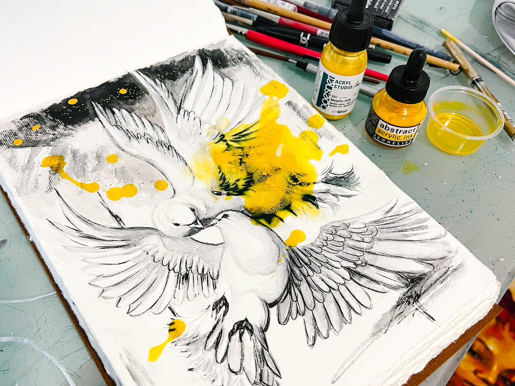 process photo of sketch of two doves with drips of yellow and black ink by artist elli milan
