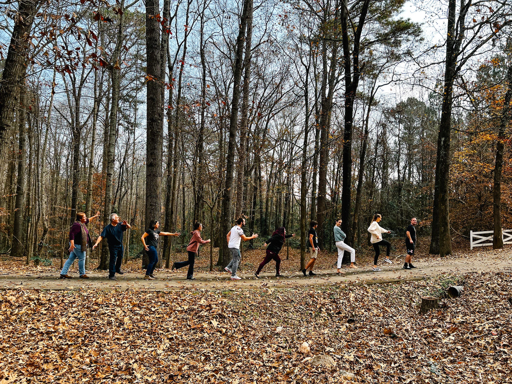 The Judges, Host, and contestants of The Outstanding Artist Season 2 pose playfulling in the Georgia Forest