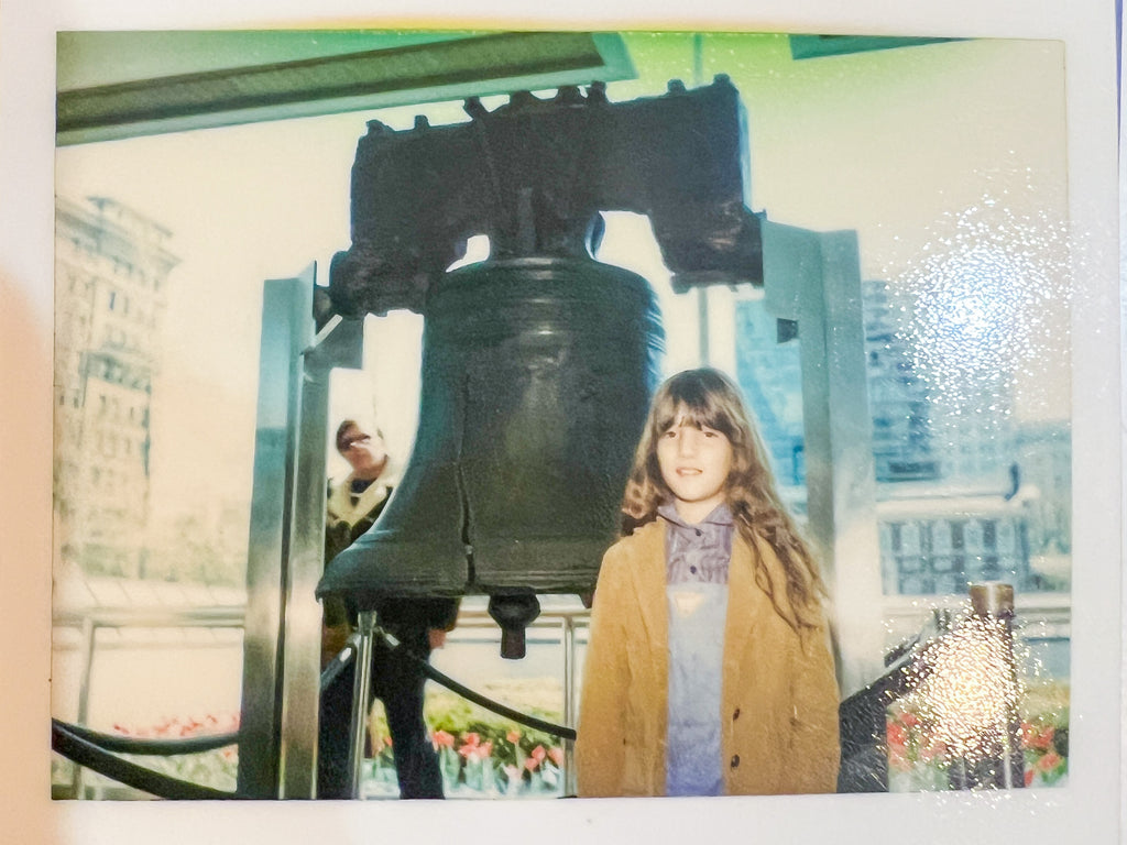 Elli Milan standing next to liberty bell