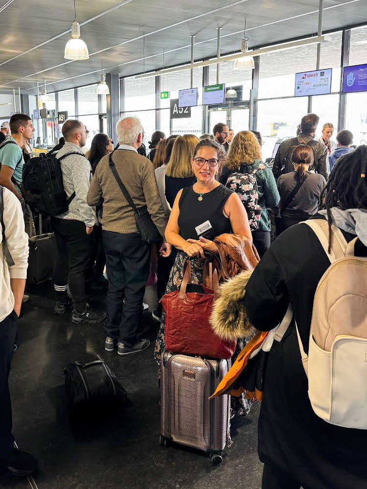 Elli waits at the gate with her luggage