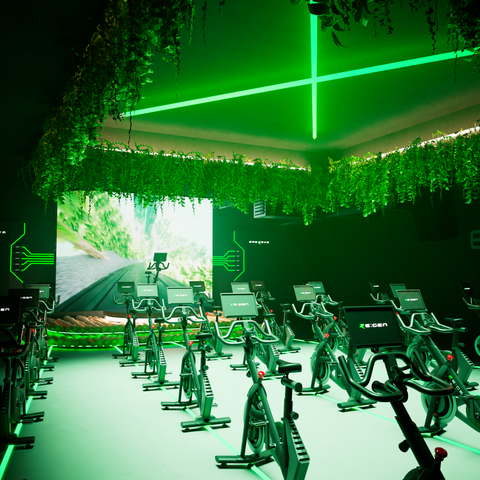 RE:GEN Studio Gym Set up with electricity-generating indoor bikes and green lighting