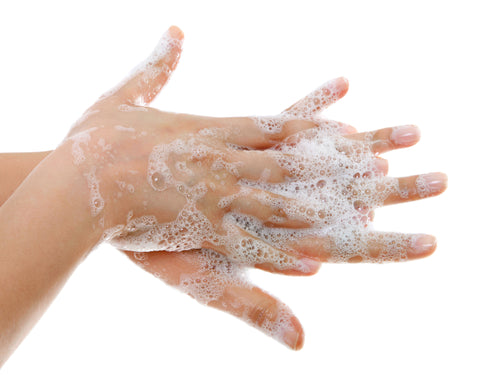 Person washing their hand with soap