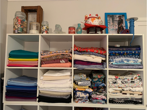 Fabric stored stacked on shelves. 