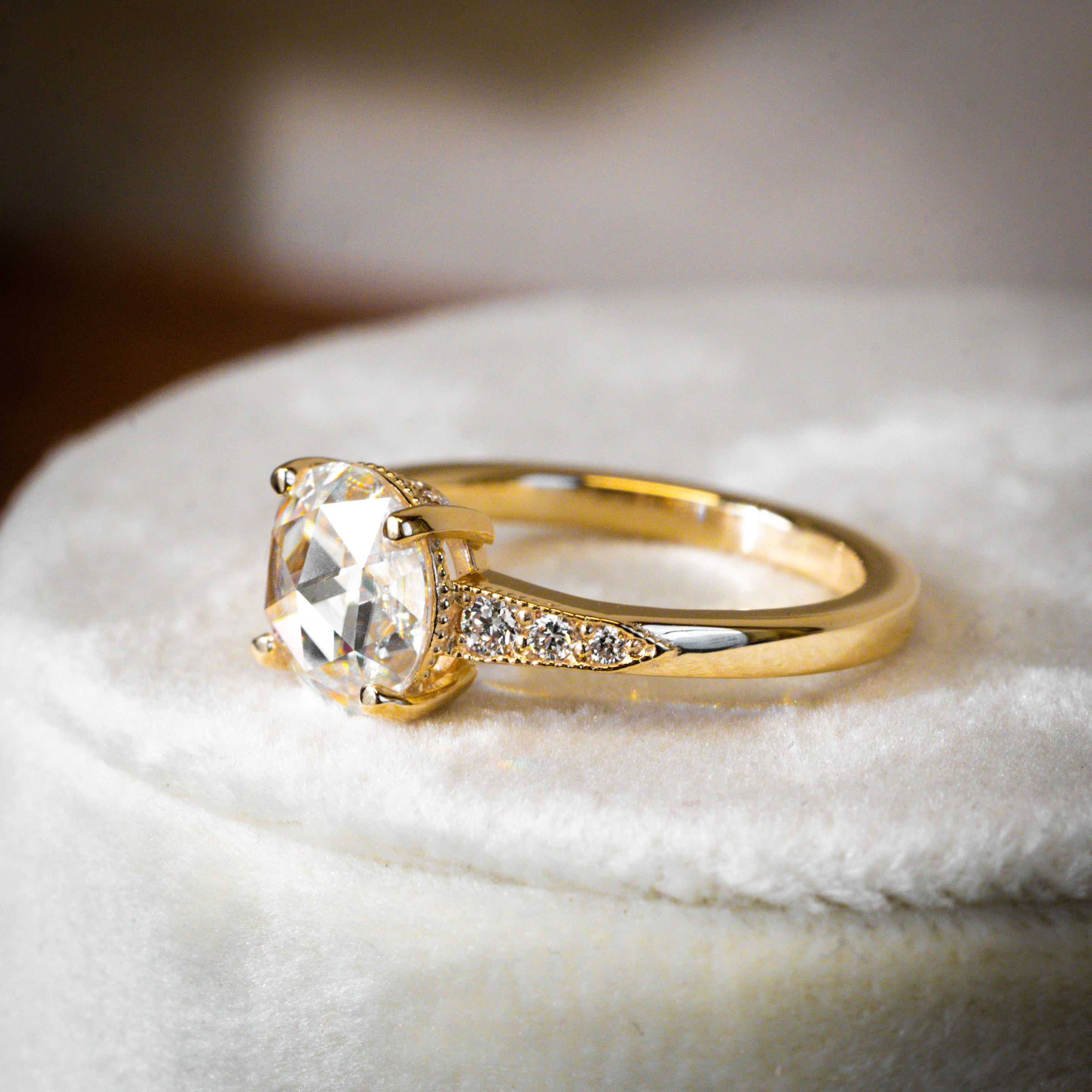 vintage inspired rose cut moissanite engagement ring with accent diamonds and milgrain