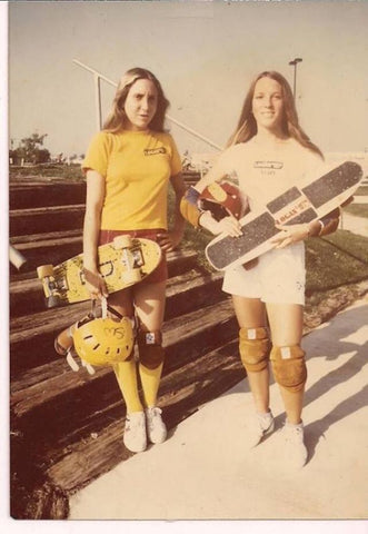 Two girls in the 1970's holding skateboards