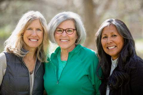 Three older women together outside