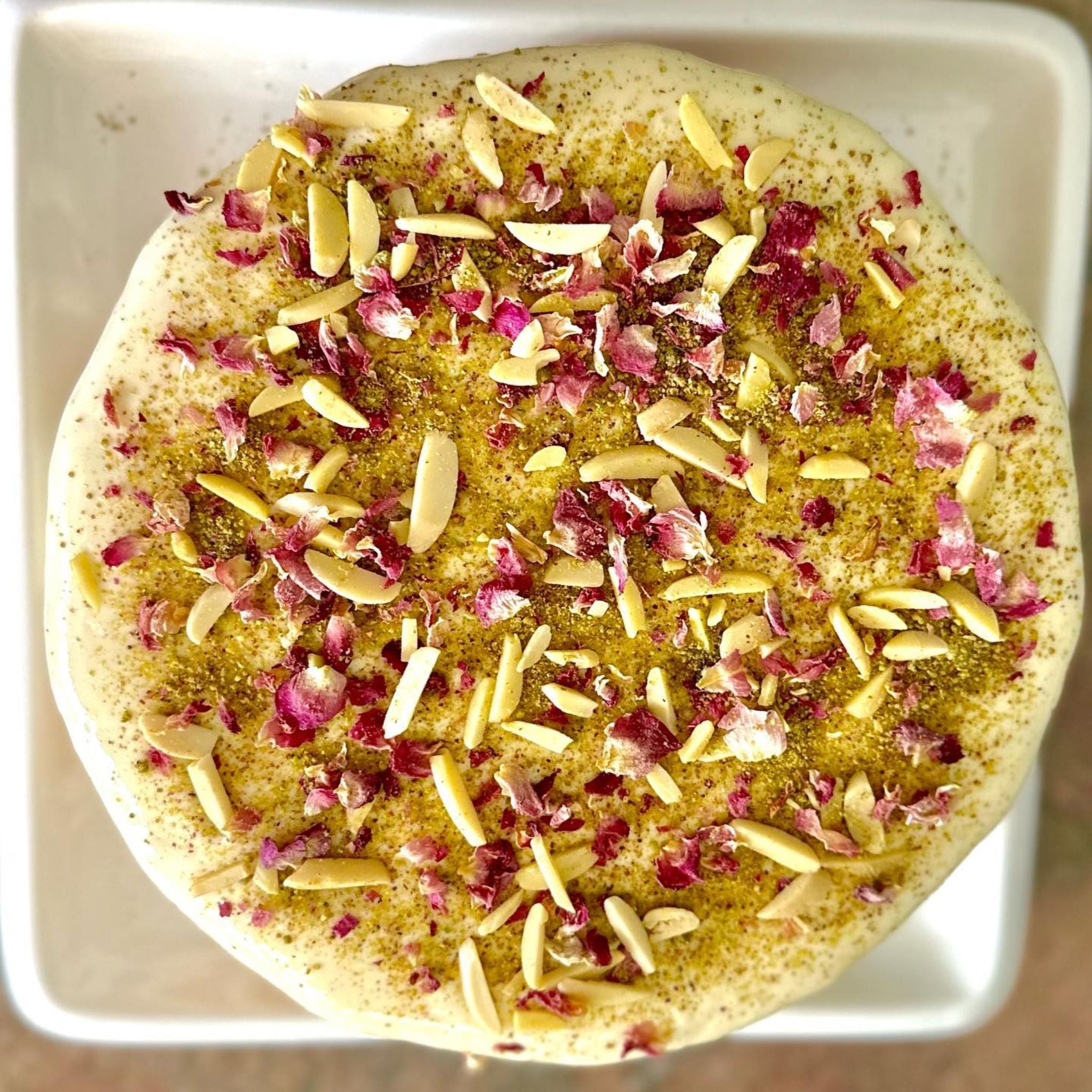 Persian Love Cake made with Exotic Bazaar Saffron Love Cake pre mix . Almond based gluten free cake with rosewater, rose petal garnish