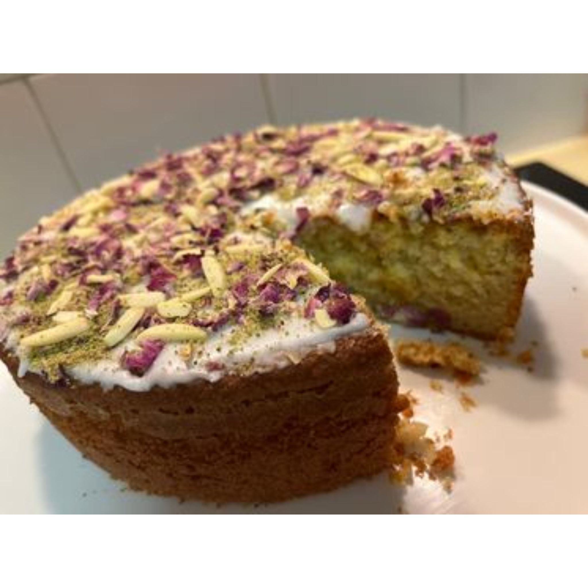 Persian Love Cake made with Exotic Bazaar Saffron Love Cake pre mix . Almond based gluten free cake with rosewater, rose petal garnish