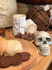 Red Hawk Cheese, Reeses Peanut Butter cups, Cana de oveja and a fake skull on a cheese board