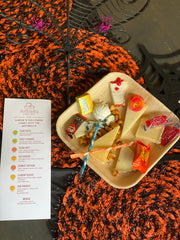 cheese plate with 7 types of cheese and 7 types of halloween candy with a menu