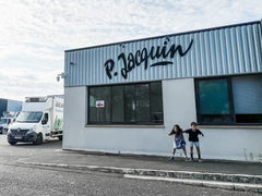 Two childrens standing in front of the P Jacquin cheese plant in Loire valley france