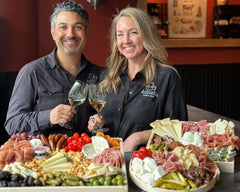 Owners John and Kendall antonelli holding glasses of wine