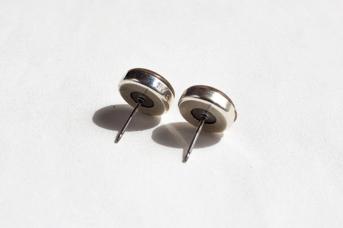 The back of Waystone's stud confluence earrings, showing the stainless steel posts welded to the sterling silver housing
