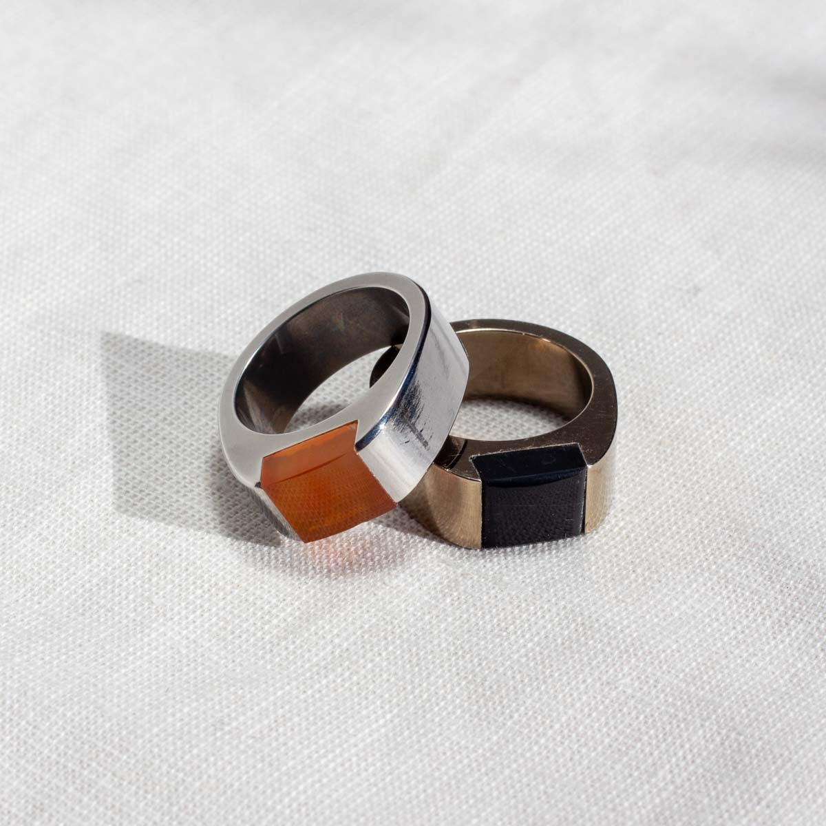 Two custom mens rings - one with a silver finish and one with a champagne finish