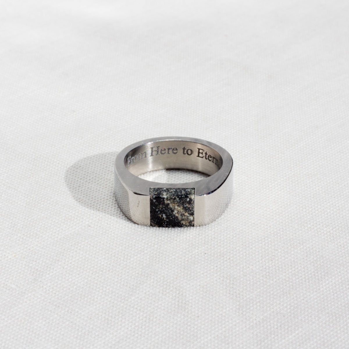 Silver color stainless ring with text engraved inside