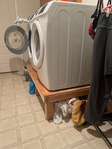 Below this ergo laundry machine stand is where several jugs and cases of water will go.