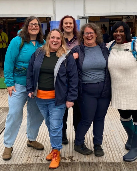 five plus size women standing in a group