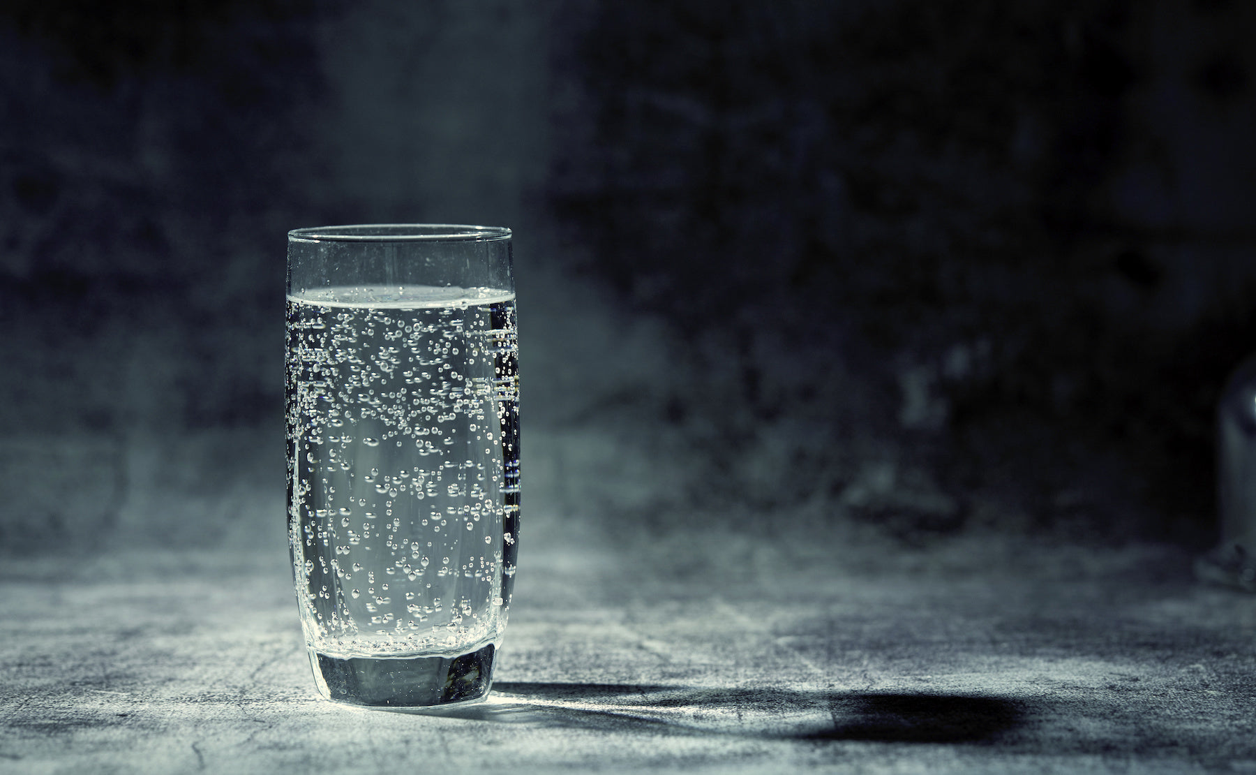 glass of water on concrete surface