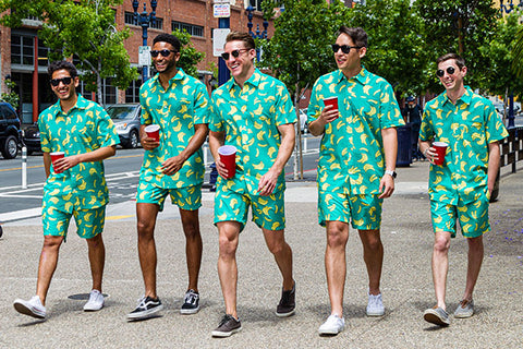 Image of models wearing rubber ducky Hawaiian shirt and rubber ducky swim trunks