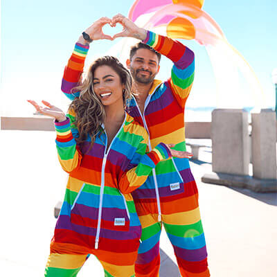image of couple wearing matching rainbow jumpsuit