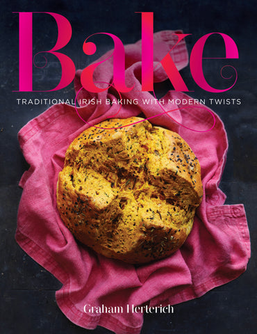 cover of Bake cookbook with pink tea towel and loaf of soda bread