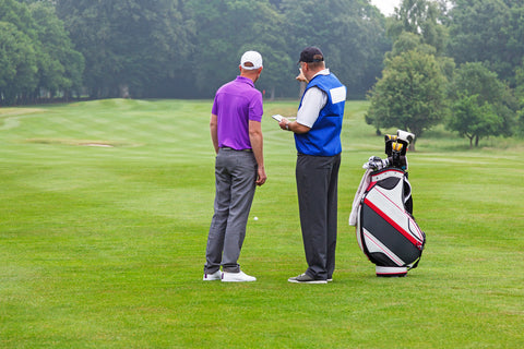 caddie pointing out hazard