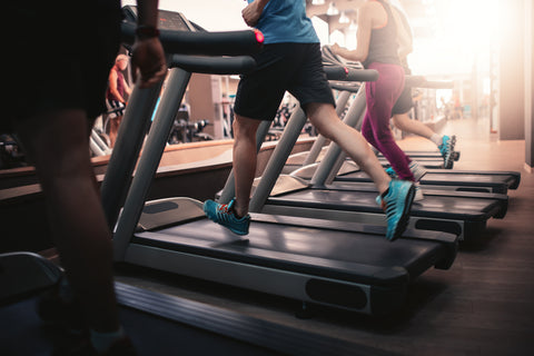 man running on treadmill in gym
