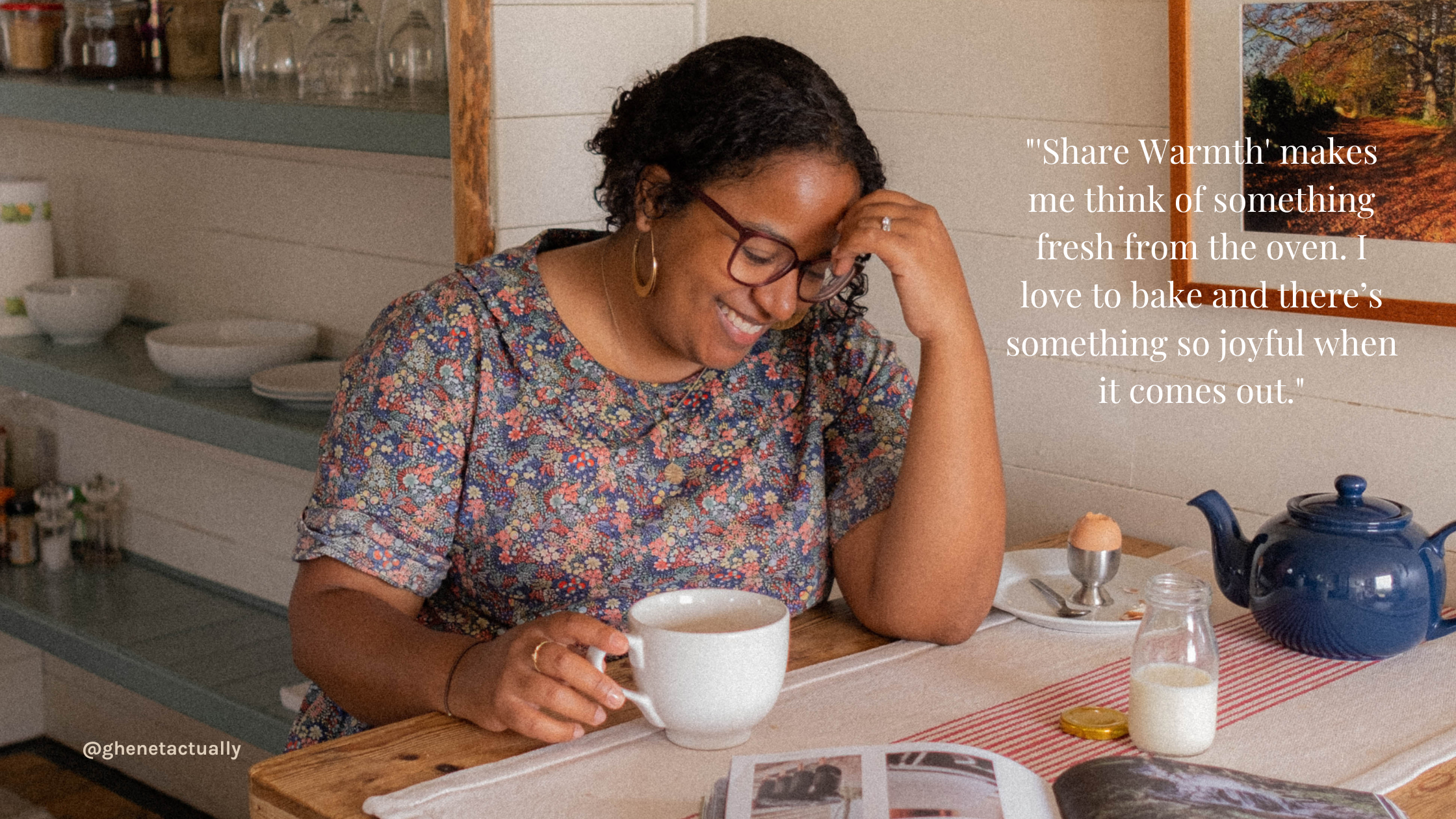 Ghenet sits at her kitchen table, cup of tea in one hand, boiled egg in cup holder to her other side.