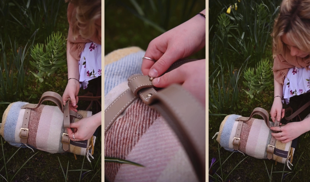 A step by step visual of somebody buckling a leather picnic blanket strap 