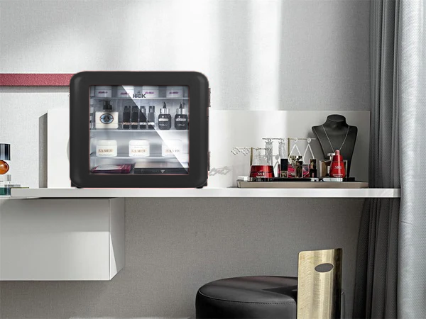 Front view of a 1.6 Cu Ft Iconic Retro Beverage Fridge positioned on a makeup table beside cosmetics. The transparent door enables the contents of the fridge to be visible