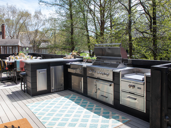 Side view of an outdoor kitchen setup with the 6.04 Cu Ft Undercounter Kegerator Outdoor Beverage Fridge installed in a suitable position under the counter