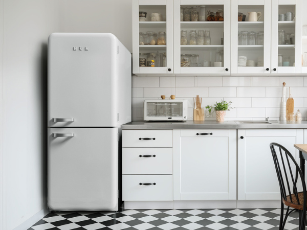 Front view of a retro-style kitchen setting featuring the 14.1 Cu Ft Bottom Freezer Iconic Retro Fridge, perfectly installed in the left corner beside a kitchen cabinet