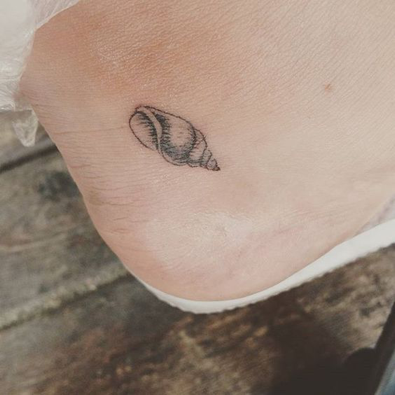 15 Beach-themed tattoos to get to feel like you're on holiday