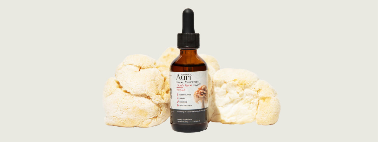 A bottle of Auri Super Mushroom Lion's Mane Elixir for focus, surrounded by fresh Lion's Mane mushrooms, offering a natural cognitive boost.