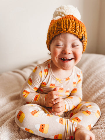 toddler boy wearing candy corn hat and 2 piece set