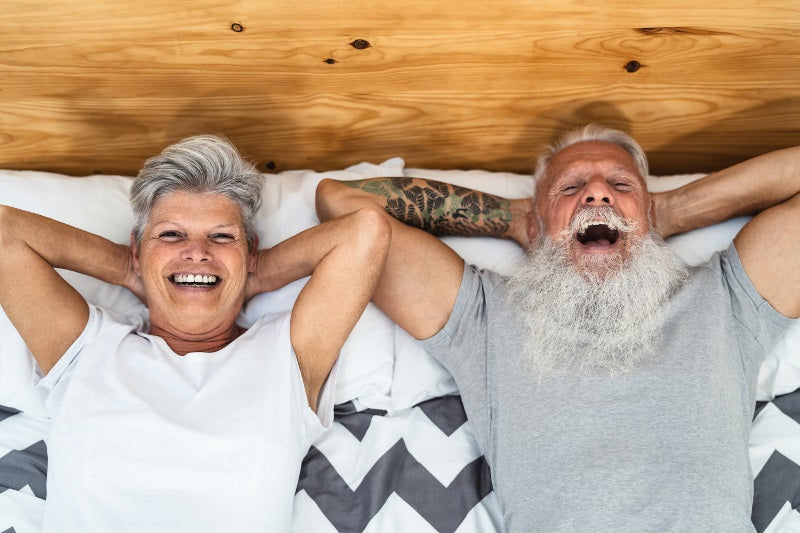 A couple is seen relaxing on a bed