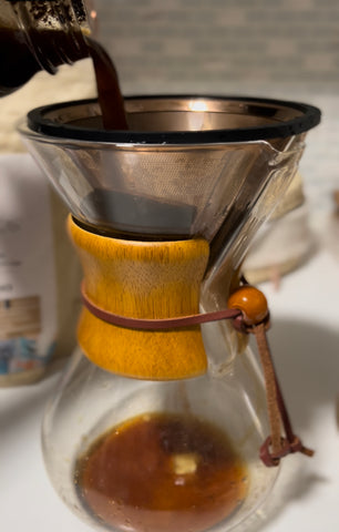 Straining coffee through metal filter