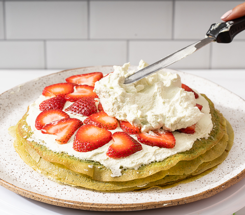 matcha crepes with fresh strawberries and whipped cream