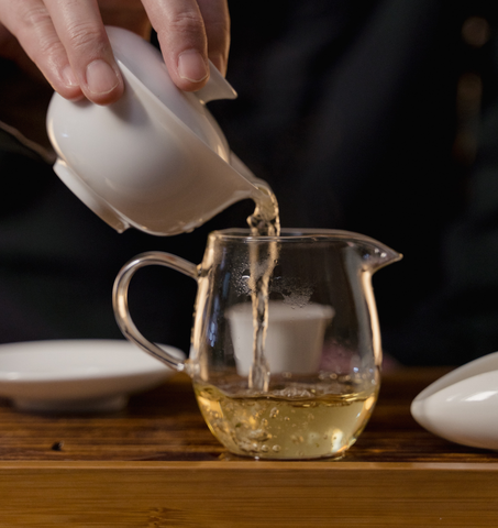 Pouring Green Tea in a cup
