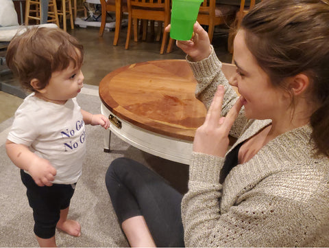 Mom shows baby how to do the sign WATER